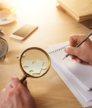 male-hands-with-pencil-magnifying-glass-1-1